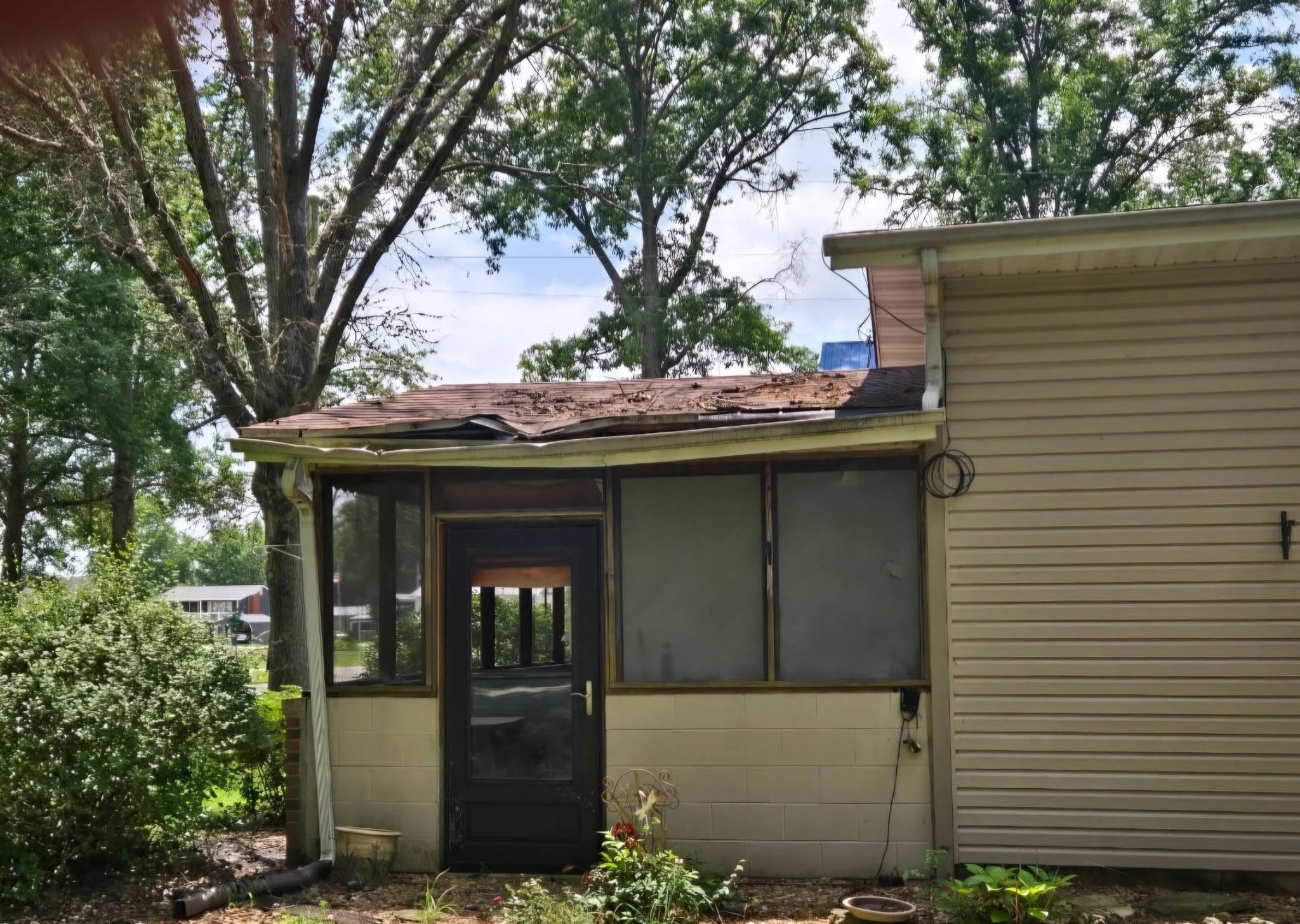 Storm damaged porch roof before restoration in Salem IL